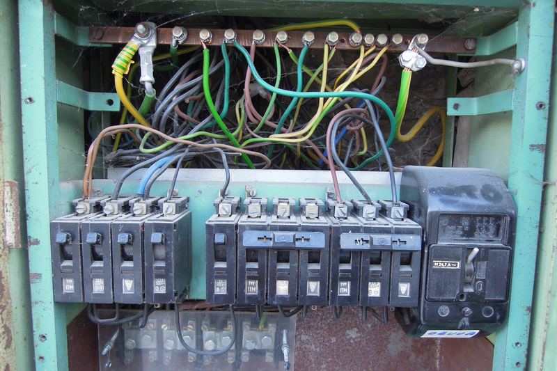Open distribution board showing wiring and breakers